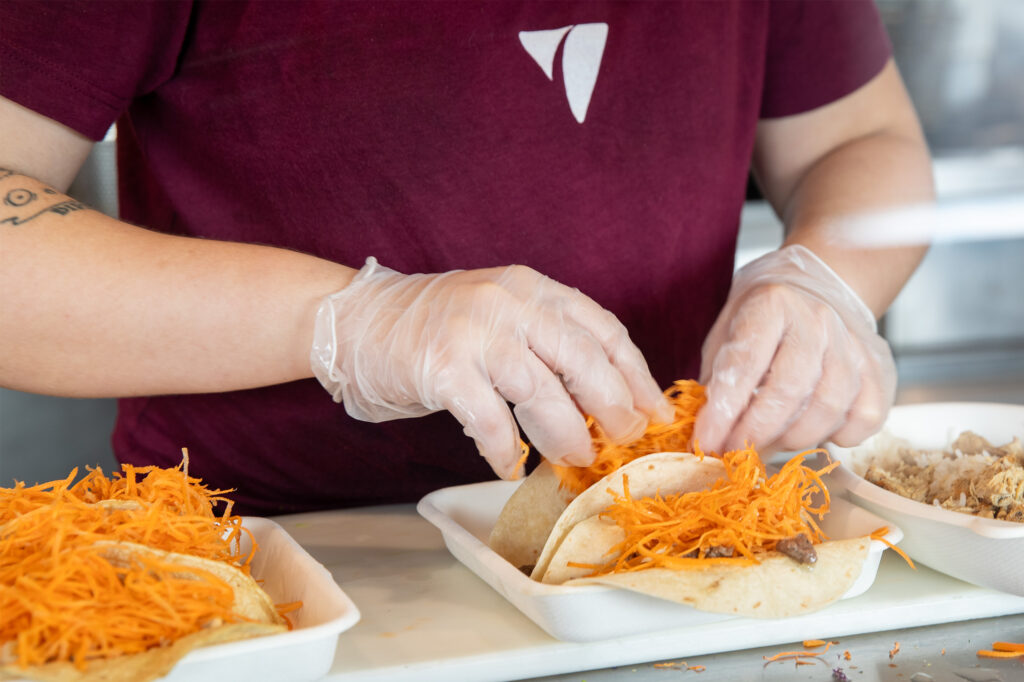 Balance employee Mia Albright makes tacos. (TFP Photo/Kevin Tiell)