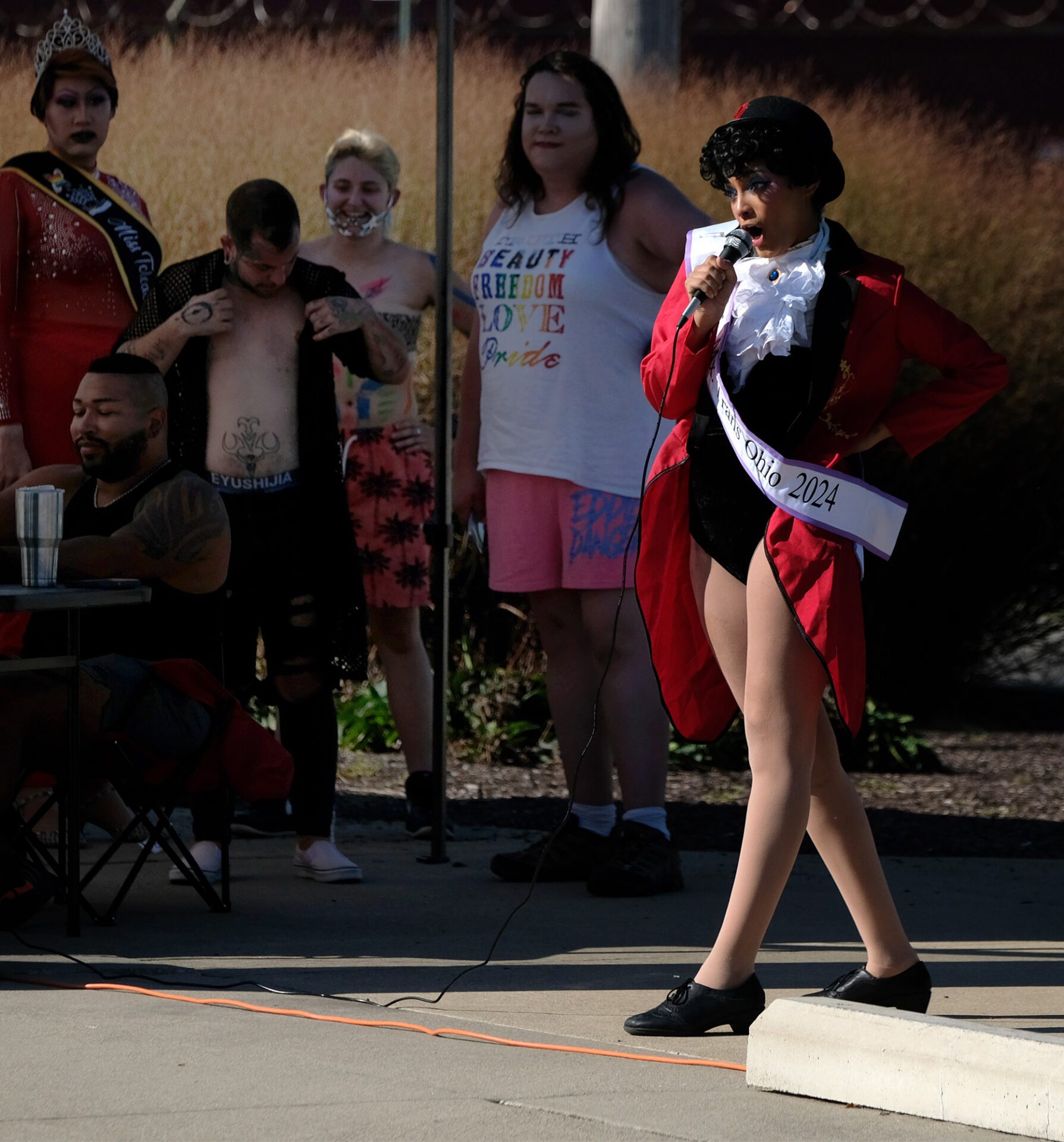 Woman with mic on stage.